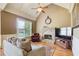 Inviting living room with stone fireplace, vaulted ceilings, and large windows at 737 Heritage Post Ln, Grayson, GA 30017