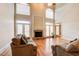 Bright living room with stone fireplace, hardwood floors, and large arched windows at 737 Heritage Post Ln, Grayson, GA 30017