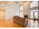 Vaulted ceilings and fireplace highlight this naturally lit living room with hardwood floors at 737 Heritage Post Ln, Grayson, GA 30017