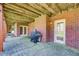 Covered patio with a brick facade, a grill, and access to the backyard at 737 Heritage Post Ln, Grayson, GA 30017