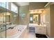 Bright bathroom featuring a large tub, big window, vanity and plenty of natural light at 772 Vinings Estates Se Dr, Mableton, GA 30126