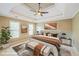 Comfortable bedroom features a tray ceiling, fan, bedside tables and neutral paint at 772 Vinings Estates Se Dr, Mableton, GA 30126