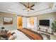 Spacious bedroom with tray ceilings, fan, large walk-in closet and neutral paint at 772 Vinings Estates Se Dr, Mableton, GA 30126