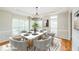 Cozy dining room features a marble table, six chairs, light fixture and plenty of natural light at 772 Vinings Estates Se Dr, Mableton, GA 30126
