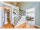 Elegant foyer with hardwood floors, staircase with iron spindles, and natural light at 772 Vinings Estates Se Dr, Mableton, GA 30126