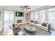 Cozy living room featuring a fireplace, built-in shelves, and lots of natural light at 772 Vinings Estates Se Dr, Mableton, GA 30126