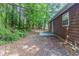 A lush backyard setting with mature trees, brown siding, and a concrete patio area at 340 Onyx Ct, Atlanta, GA 30349