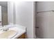 Practical bathroom featuring a modest wood vanity with sink and a partial view of the shower and tub at 340 Onyx Ct, Atlanta, GA 30349