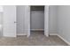 Bedroom with neutral walls and carpet and an open closet with plenty of space for storage at 340 Onyx Ct, Atlanta, GA 30349