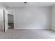 Empty bedroom with neutral walls and carpet plus access to additional space through a pair of doors at 340 Onyx Ct, Atlanta, GA 30349