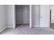 Bedroom with neutral carpeting, gray walls, and an open closet with rod at 340 Onyx Ct, Atlanta, GA 30349