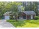 Charming one-story home featuring a well-manicured lawn, attached garage, and classic design at 340 Onyx Ct, Atlanta, GA 30349