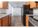 Functional kitchen with stainless steel appliances, wood cabinets, and wood floors at 340 Onyx Ct, Atlanta, GA 30349
