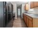 Functional kitchen featuring stainless steel appliances, wood cabinets, and wood floors at 340 Onyx Ct, Atlanta, GA 30349