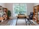 Well-appointed home office with bookshelves, wood floors, and a view of the outdoors at 340 Onyx Ct, Atlanta, GA 30349
