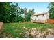 A lush green yard surrounds the deck and the house is surrounded by lush green trees at 3664 Nessa Se Ct, Smyrna, GA 30082