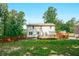 View of home's backyard with the newly constructed deck, green grass, and privacy fence for added security at 3664 Nessa Se Ct, Smyrna, GA 30082