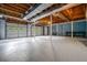 This unfinished basement features a garage door, blue walls, and an exposed ceiling at 3664 Nessa Se Ct, Smyrna, GA 30082