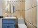 Powder room with sink, granite countertops, updated lighting, and tile walls at 3664 Nessa Se Ct, Smyrna, GA 30082
