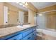 This bathroom boasts blue cabinets with granite counters, and a shower with glass doors at 3664 Nessa Se Ct, Smyrna, GA 30082