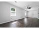 This bedroom features wood-look flooring, neutral walls, a ceiling fan, and a window for plenty of natural light at 3664 Nessa Se Ct, Smyrna, GA 30082