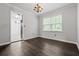 Elegant dining room with hardwood floors, a chandelier, and large windows, perfect for entertaining guests at 3664 Nessa Se Ct, Smyrna, GA 30082