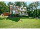 Beautiful two-story home with a bay window and inviting front porch, nestled among lush greenery at 3664 Nessa Se Ct, Smyrna, GA 30082