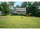 Charming two-story home with a well-manicured lawn and mature trees, creating a welcoming curb appeal at 3664 Nessa Se Ct, Smyrna, GA 30082