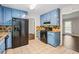 Cozy kitchen with blue cabinets, granite counters, and stainless steel appliances, connecting seamlessly to other rooms at 3664 Nessa Se Ct, Smyrna, GA 30082