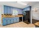 Well-lit kitchen with blue cabinets, granite countertops, and modern appliances, offering style and functionality at 3664 Nessa Se Ct, Smyrna, GA 30082