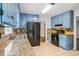 The kitchen features updated blue cabinets, stainless steel appliances, and tile flooring at 3664 Nessa Se Ct, Smyrna, GA 30082