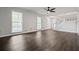 Open living area with hardwood floors, bright windows, and a staircase, creating a seamless flow at 3664 Nessa Se Ct, Smyrna, GA 30082