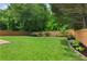 Expansive backyard offers a well-maintained lawn and privacy fence, perfect for outdoor activities and relaxation at 4018 Rhyne Se Cir, Smyrna, GA 30082