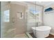 Bright bathroom with a glass shower and free standing bathtub by window at 4018 Rhyne Se Cir, Smyrna, GA 30082