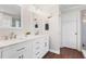 Bright bathroom featuring dual sinks, marble countertops and wood floors at 4018 Rhyne Se Cir, Smyrna, GA 30082
