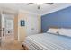 Bedroom featuring blue accent wall, bed, and entry to hallway at 4018 Rhyne Se Cir, Smyrna, GA 30082