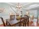 Elegant dining room with hardwood floors, wainscoting, and a modern chandelier above the table at 4018 Rhyne Se Cir, Smyrna, GA 30082