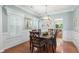 Elegant dining room with hardwood floors, wainscoting, and a modern chandelier above the table at 4018 Rhyne Se Cir, Smyrna, GA 30082