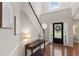 Bright foyer with hardwood floors, a staircase, and a decorative front door with sidelights at 4018 Rhyne Se Cir, Smyrna, GA 30082
