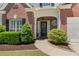 Close-up of the front entrance showcasing a decorative wreath, landscaping, and brick facade at 4018 Rhyne Se Cir, Smyrna, GA 30082