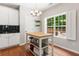 Bright kitchen featuring a kitchen island, white cabinets, and a window with a view of the backyard at 4018 Rhyne Se Cir, Smyrna, GA 30082