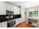 Well-lit kitchen with stainless steel appliances, granite countertops, and a kitchen island at 4018 Rhyne Se Cir, Smyrna, GA 30082