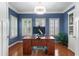 Dedicated office space boasts a hardwood floor, shutters, and built-in shelving at 4018 Rhyne Se Cir, Smyrna, GA 30082