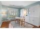 Bright study with hardwood floors, built-in shelves, and a window with shutters at 4018 Rhyne Se Cir, Smyrna, GA 30082