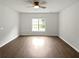 This bright bedroom is complete with ceiling fan and hardwood floors at 5480 Walnut Ln, Lithonia, GA 30038
