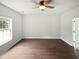 Bright bedroom with a ceiling fan, large window, and wood flooring at 5480 Walnut Ln, Lithonia, GA 30038