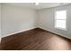 Bedroom with wood floors features lots of natural light from the window at 5480 Walnut Ln, Lithonia, GA 30038