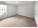Sunny carpeted bedroom with a bright window at 5480 Walnut Ln, Lithonia, GA 30038