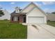 Charming home with a well-maintained lawn and a two-car garage at 5480 Walnut Ln, Lithonia, GA 30038