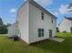 Exterior view of the home features a well-maintained lawn and vinyl siding at 5480 Walnut Ln, Lithonia, GA 30038
